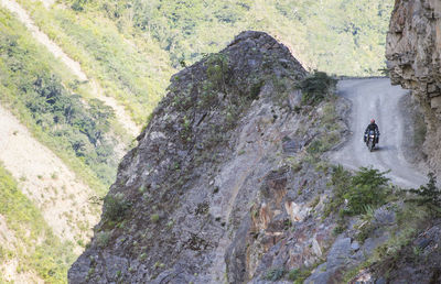 Reflection of person riding in mountains