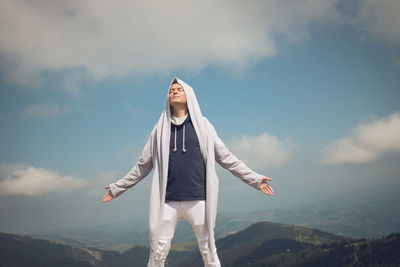 Low angle view of man standing against sky