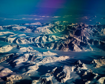 Aerial view of snowcapped mountains against sky