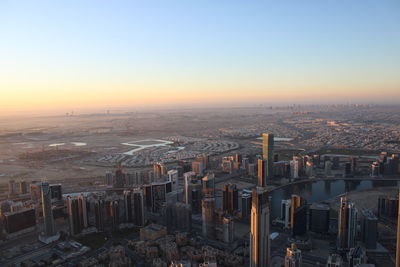 High angle view of buildings in city during sunset