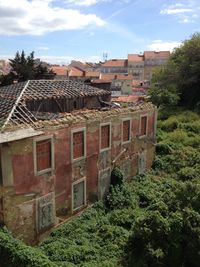 Buildings against cloudy sky