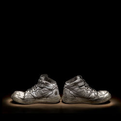 Close-up of shoes over black background