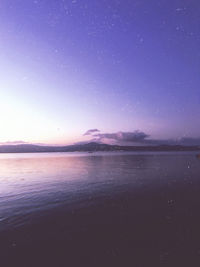 Scenic view of sea against blue sky at night