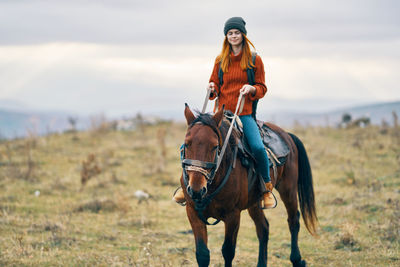 Man riding horse on field