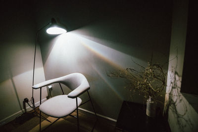 Illuminated lamp on table at home