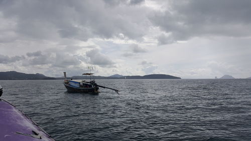 Boat sailing in sea against sky