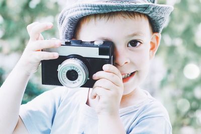 Portrait of boy photographing with camera