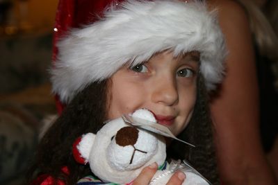 Close-up portrait of cute girl holding stuffed toy