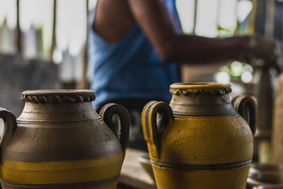 Midsection of man standing in pots