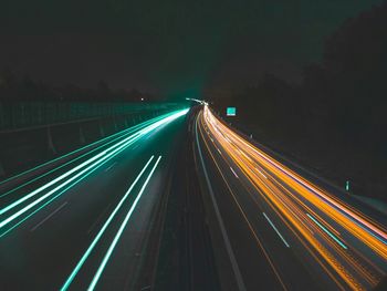 Light trails on road in city at night