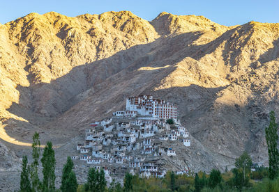 Scenic view of mountain against buildings