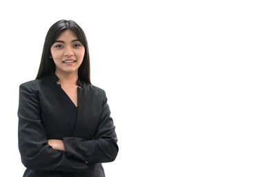 Portrait of young woman against white background