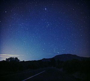 Scenic view of silhouette road against sky at night