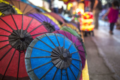 Colorful handmade paper umbrellas at traditional street night market in luang prabang, laos.