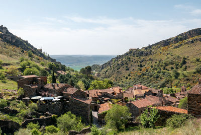 High angle view of buildings and trees against sky