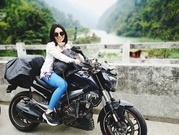Portrait of young woman riding motorcycle