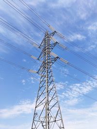 Low angle view of electricity pylon against sky