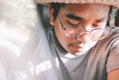 Close-up portrait of young man wearing eyeglasses