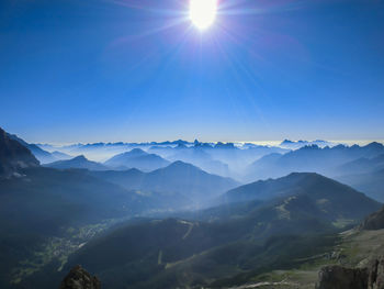 Scenic view of mountains against sky on sunny day