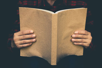 Close-up of hand holding book