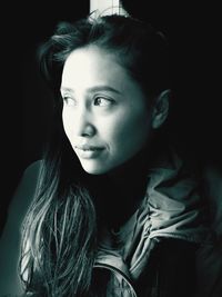 Close-up of young woman looking away