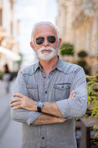 Portrait of man wearing hat standing outdoors