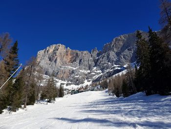 Scenic view of snowcapped mountains against clear blue sky