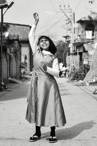 Cute girl playing with toy while standing on street