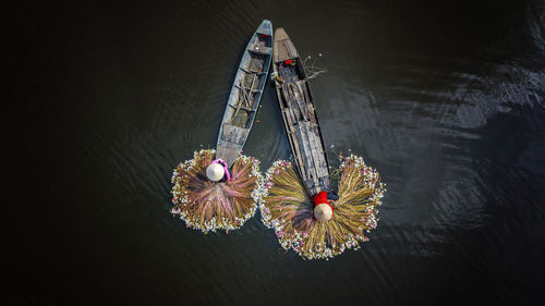 Aerial view of fisherman sitting on boat in river