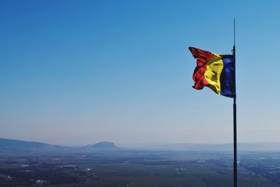 Flag against clear blue sky