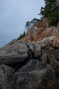 Low angle view of rock formation on mountain against sky