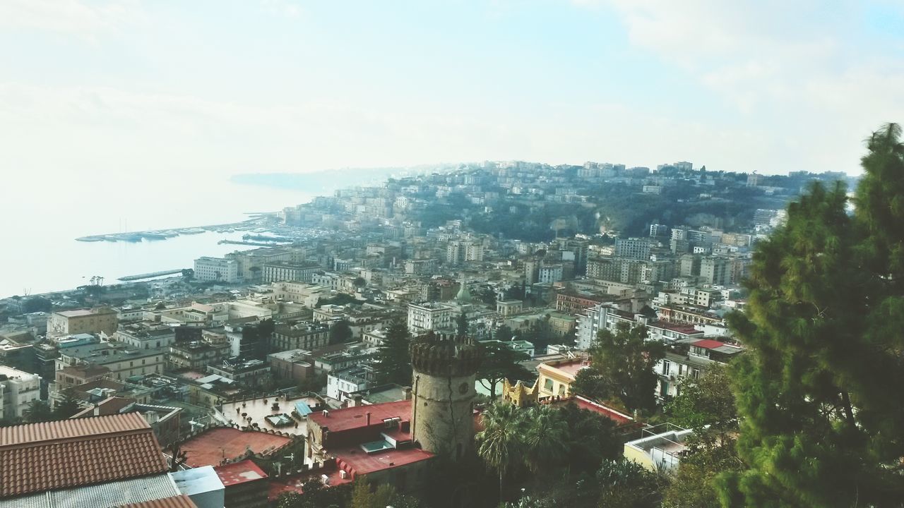 building exterior, architecture, built structure, cityscape, city, residential district, high angle view, crowded, mountain, residential building, residential structure, sky, house, tree, town, roof, townscape, community, human settlement, day