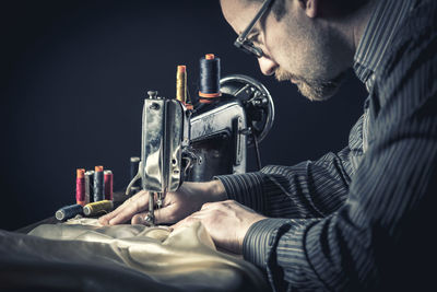 Man using sewing machine