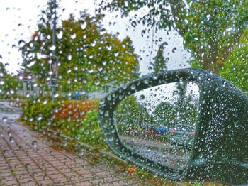 Close-up of wet glass window during rainy season