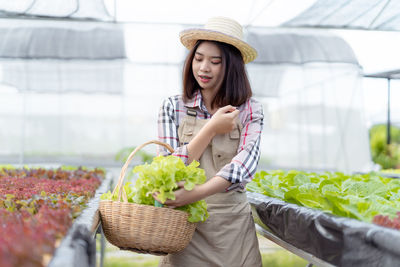 Young woman with hat in basket