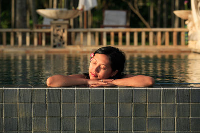 Woman with closed eyes in swimming pool