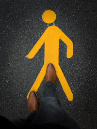 Low section of person standing on road