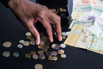 Close-up of hand holding coins