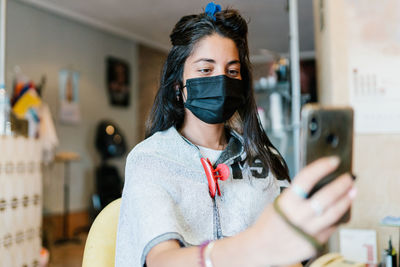 Portrait of young woman using mobile phone