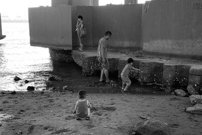 Full length of children playing in water