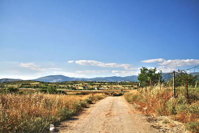 Empty road along countryside landscape