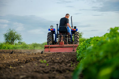 Kherson oblast, ukraine - may 29, 2021. a farmer on a tractor works in the field. 