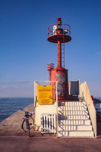 Lifeguard hut on beach against clear blue sky