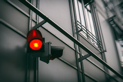 Low angle view of road signal against illuminated building