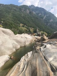 Scenic view of river and mountains against sky