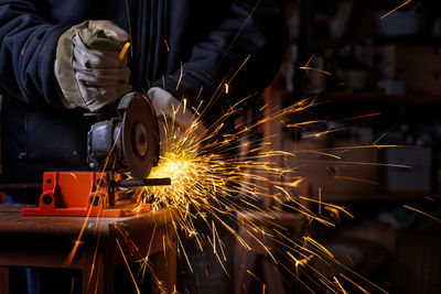 Midsection of worker working in factory