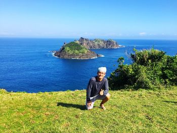 Rear view of woman sitting on beach