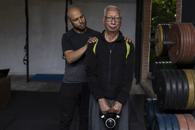 Side view of man standing in gym