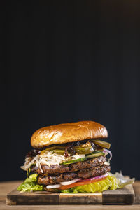 Close-up of burger against black background