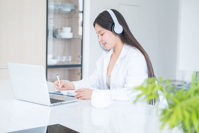 Portrait of young businesswoman working at clinic